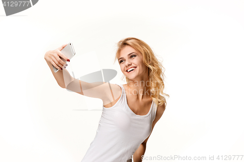 Image of Portrait of beautiful smiling girl with modern l phone