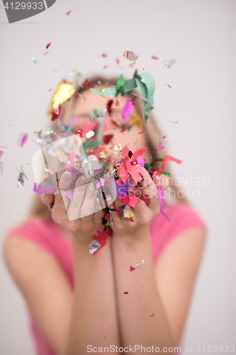 Image of woman blowing confetti in the air