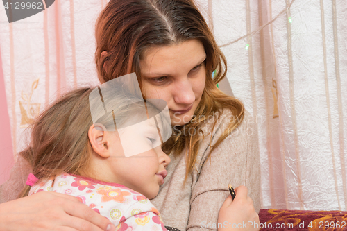 Image of Sad five year old girl hugging her mother