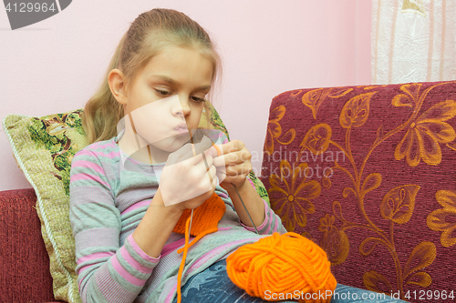 Image of The girl thought doing Knitting