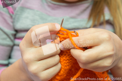 Image of Close-up of children hands to knit with needles