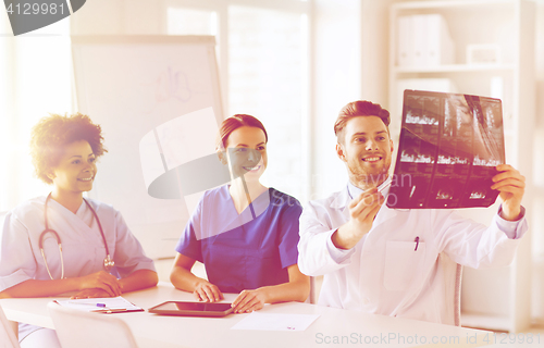 Image of group of happy doctors discussing x-ray image