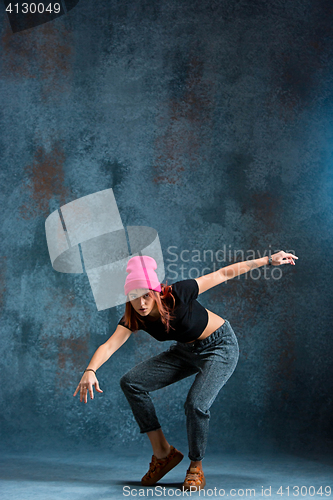 Image of Young girl break dancing on wall background.