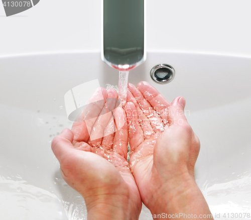 Image of washing hands in sink