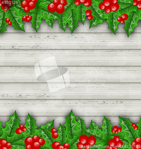 Image of Christmas decoration holly berry branches on wooden background 