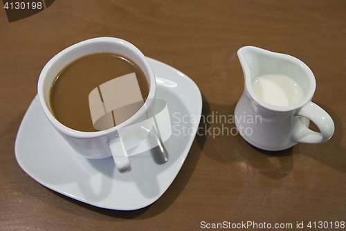 Image of Cup of coffee and milk jar