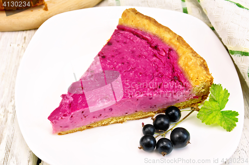 Image of Pie of black currants in plate on board