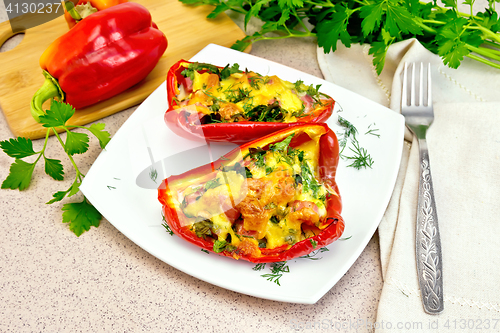 Image of Pepper stuffed with sausage and cheese in plate on granite table