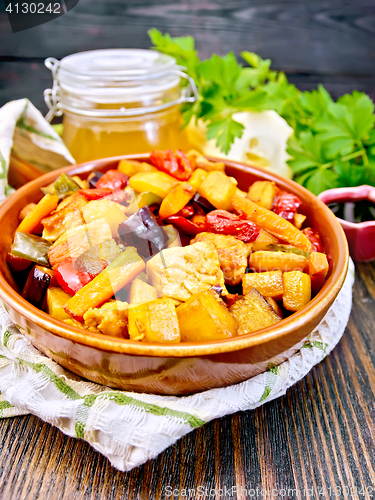 Image of Roast with vegetables and meat in pan on board