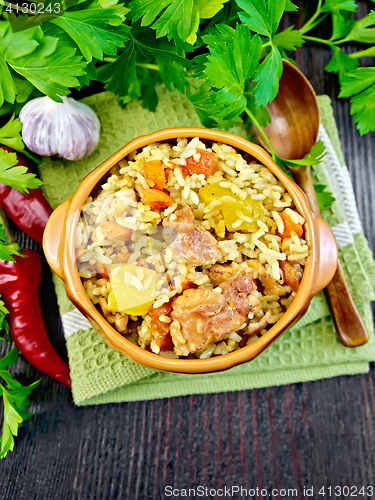 Image of Rice with chicken and zucchini in bowl on board top