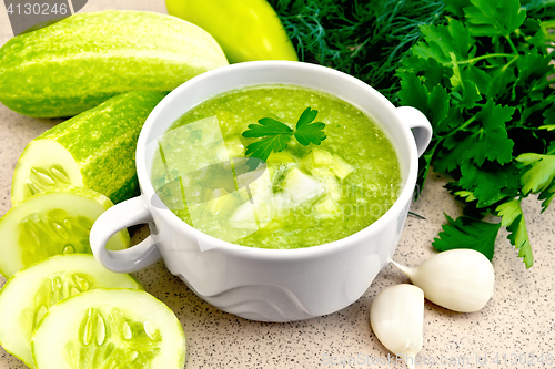 Image of Soup cucumber in white bowl on granite table