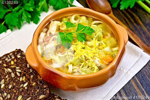 Image of Soup Minestrone in clay bowl on board