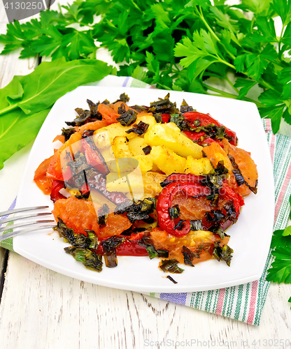 Image of Courgettes with vegetables in plate on light board