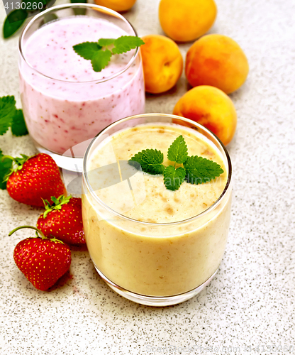 Image of Milkshake apricot and strawberry on granite table