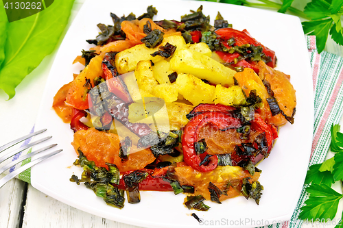 Image of Courgettes with vegetables in plate on board