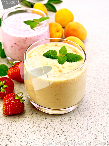 Image of Milkshake apricot and strawberry on stone table