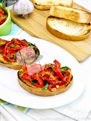 Image of Bruschetta with vegetables in plate on board