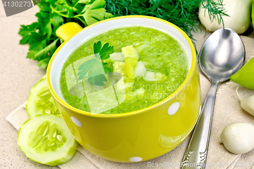 Image of Soup cucumber in yellow bowl on granite table