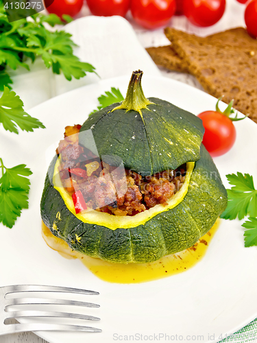 Image of Squash green stuffed with meat and vegetables on light board