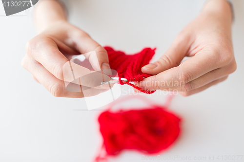 Image of woman hands knitting with needles and yarn