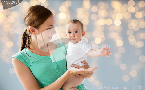 Image of happy young mother with little baby