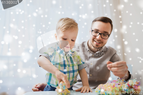 Image of father and son playing with ball clay at home