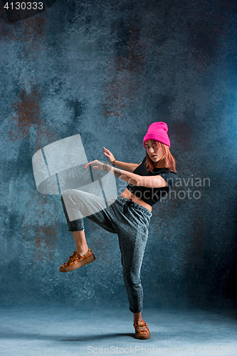 Image of Young girl break dancing on wall background.