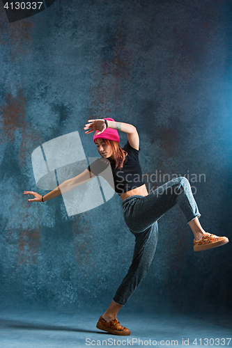 Image of Young girl break dancing on wall background.