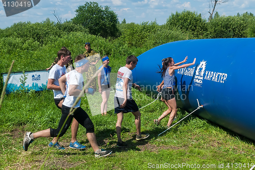 Image of Athletes overcome inflatable obstacle. Tyumen