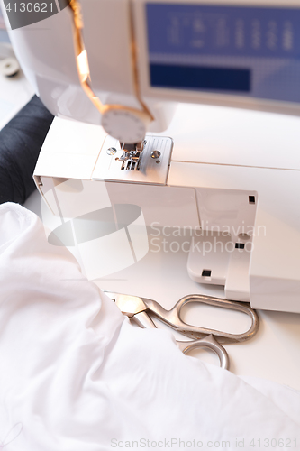 Image of Sewing-machine with cloth on table