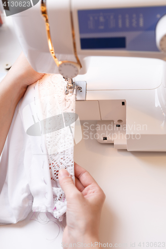 Image of Photos of sewing-machine, hands girl