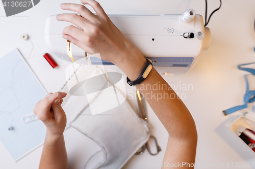 Image of Woman with sewing-machine top view