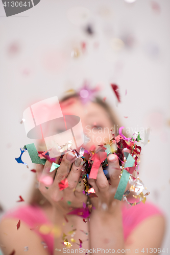 Image of woman blowing confetti in the air