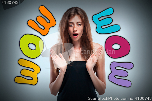 Image of Portrait of young woman with shocked facial expression