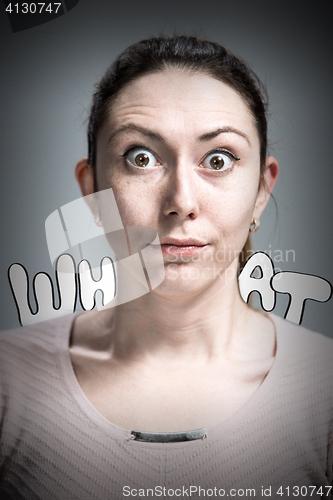 Image of Portrait of young woman with shocked facial expression