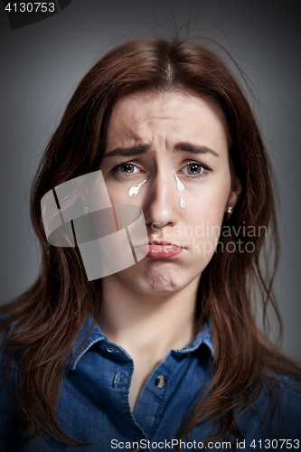 Image of The portrait of a beautiful sad girl closeup