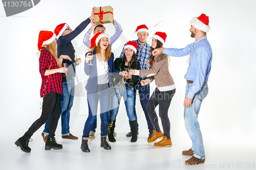 Image of Many young women and men drinking at christmas party