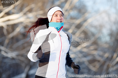 Image of Young brunette engaged in running