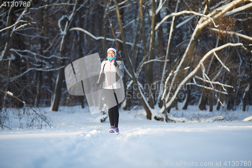 Image of Young sportswoman on morning jog