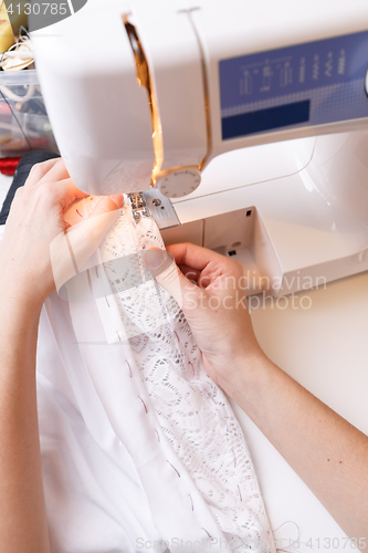 Image of Photos of sewing-machine, seamstress hands