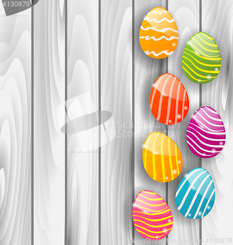 Image of Easter glossy colorful eggs on grey wooden texture