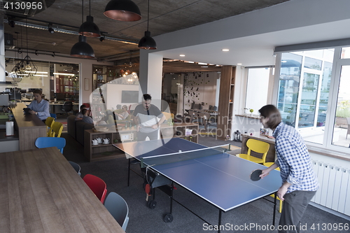 Image of playing ping pong tennis at creative office space