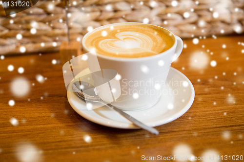 Image of close up of coffee cup with heart shape drawing