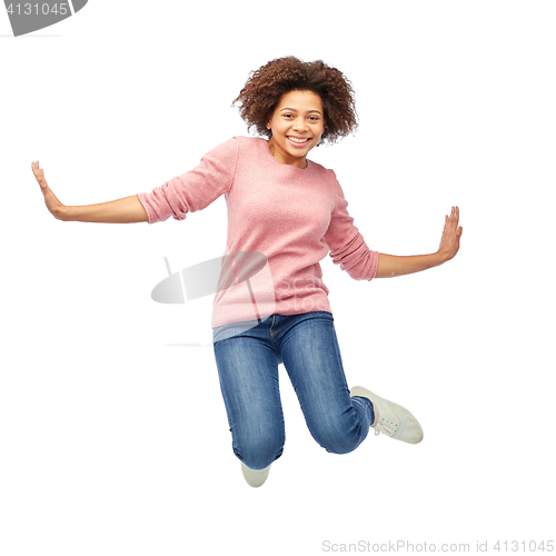 Image of happy african american woman jumping over white