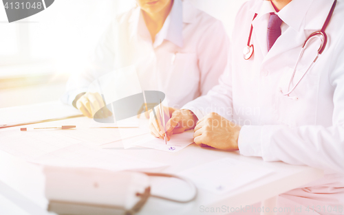 Image of doctor and nurse writing prescription paper