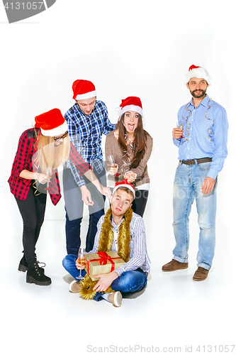 Image of Many young women and men drinking at christmas party