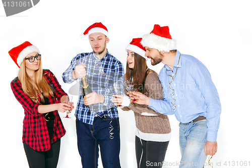 Image of Many young women and men drinking at christmas party