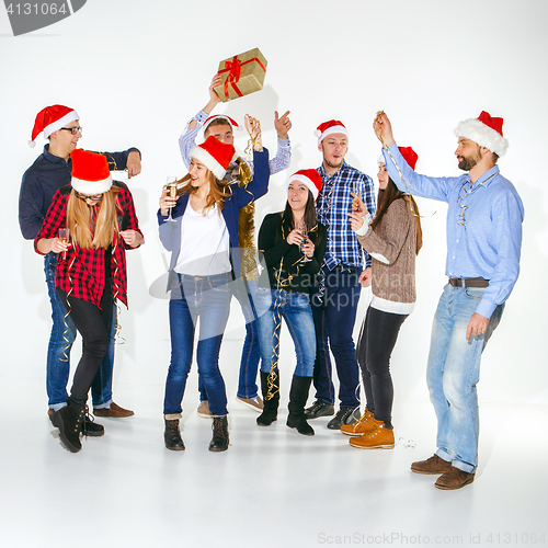 Image of Many young women and men drinking at christmas party