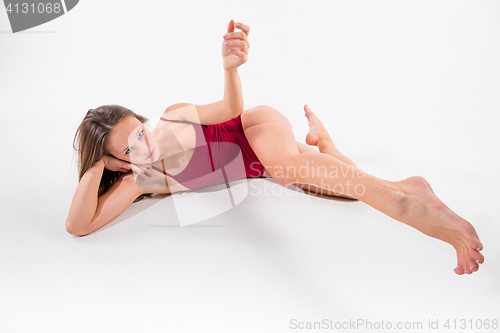 Image of Young beautiful dancer in beige dress dancing on white background