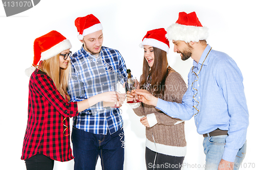 Image of Many young women and men drinking at christmas party